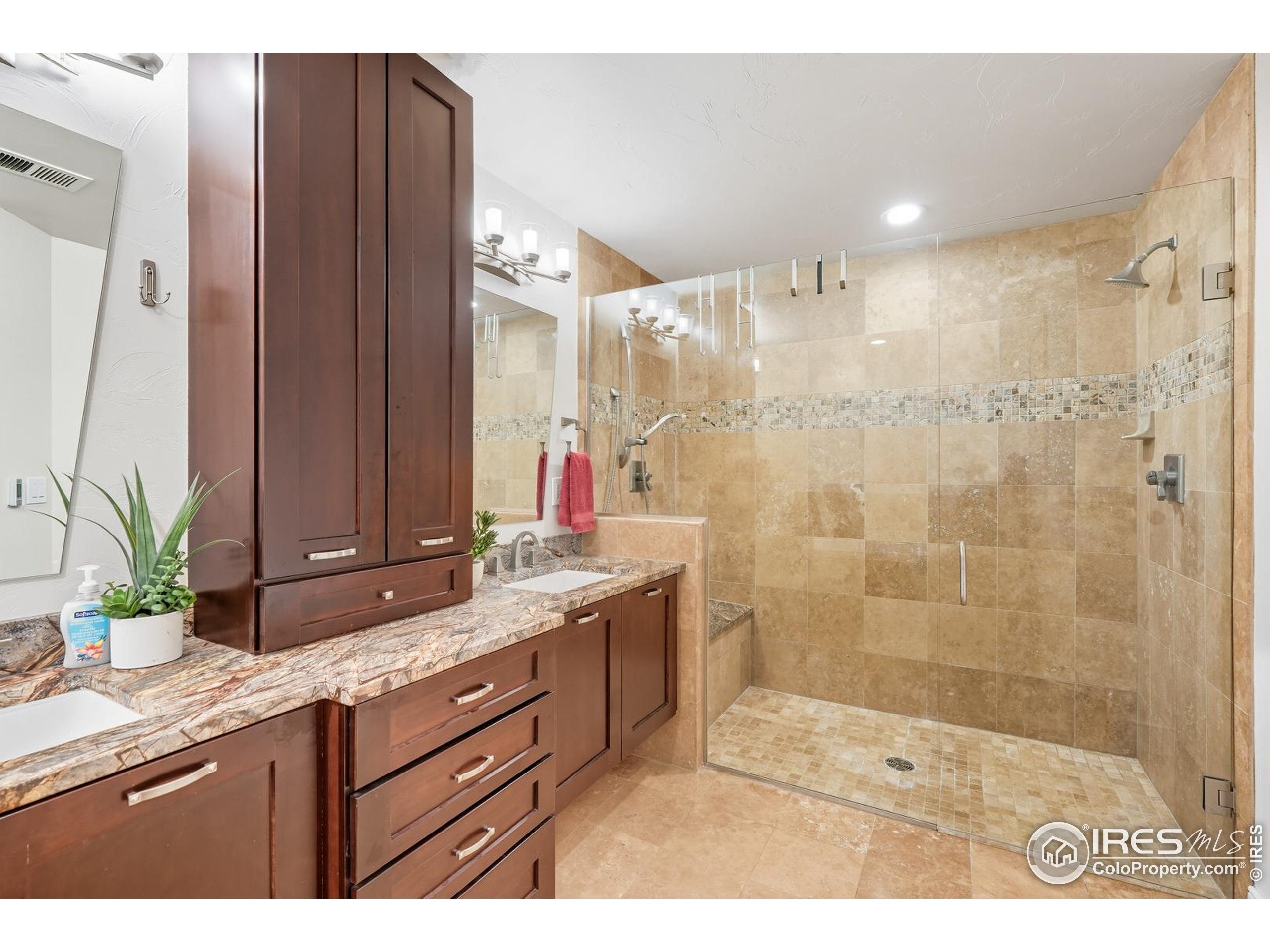 2801 Pennsylvania Avenue, Unit 203 Boulder, CO 80303 - Photo 18 of 50 a bathroom with a granite countertop sink a mirror and a shower