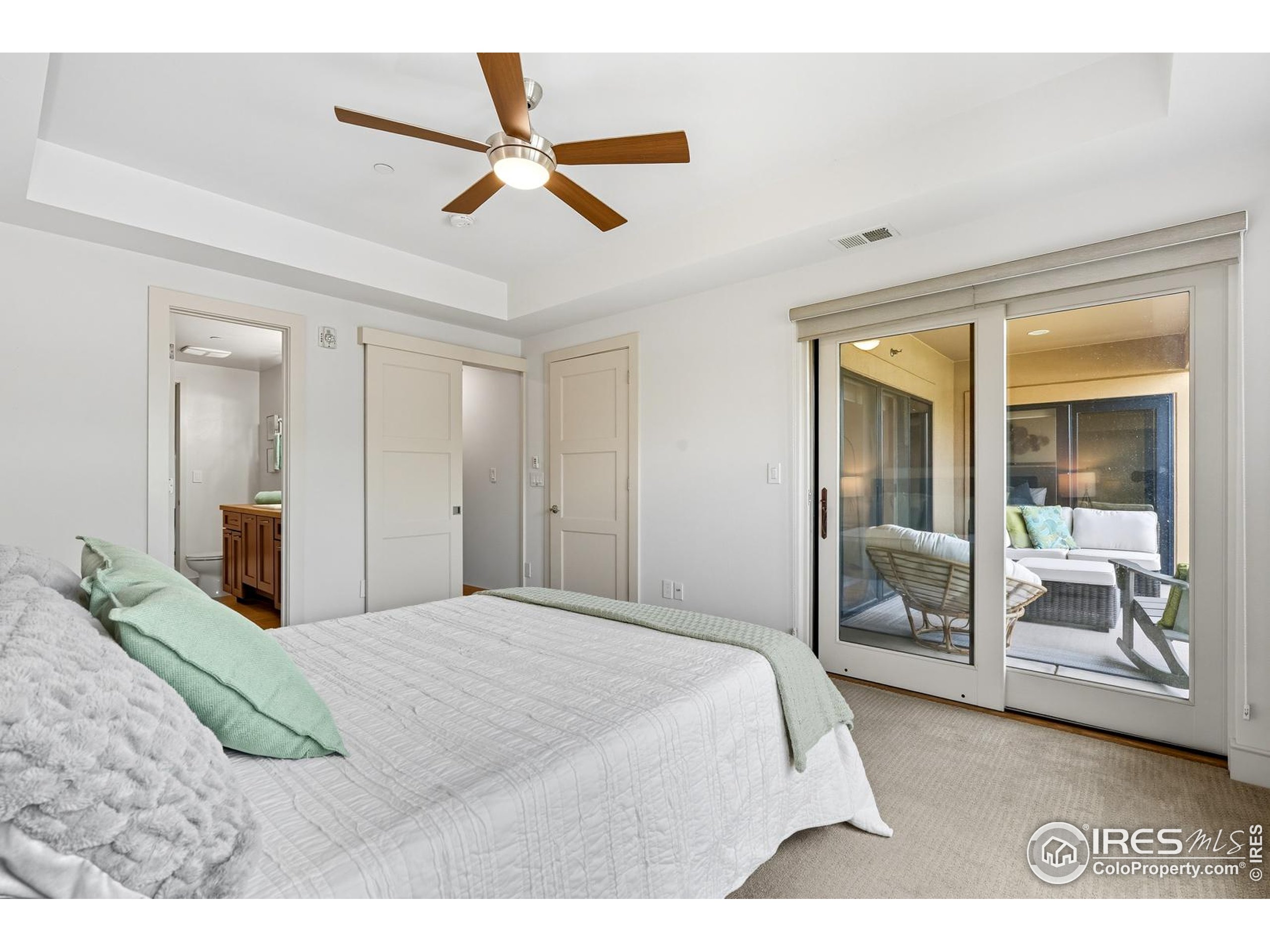 2801 Pennsylvania Avenue, Unit 203 Boulder, CO 80303 - Photo 20 of 50 a bedroom with a large bed and a chandelier