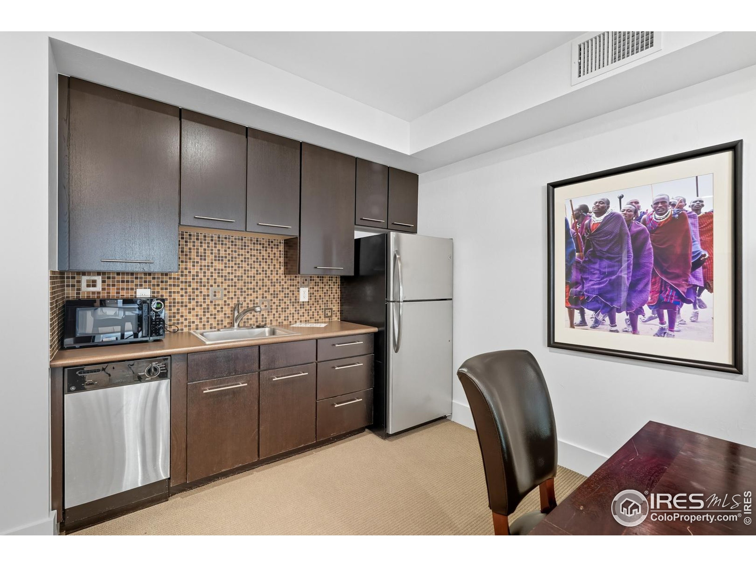 2801 Pennsylvania Avenue, Unit 203 Boulder, CO 80303 - Photo 31 of 50 a kitchen with stainless steel appliances granite countertop a refrigerator a sink a stove a dining table and chairs