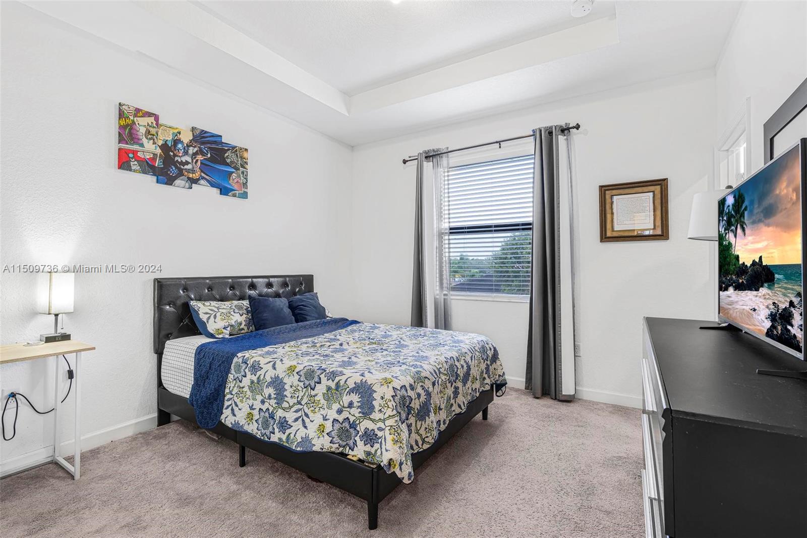 18180 Southwest 148th Road, Unit 18180 Miami, FL 33187 - Photo 11 of 29 a bedroom with a bed and a flat screen tv