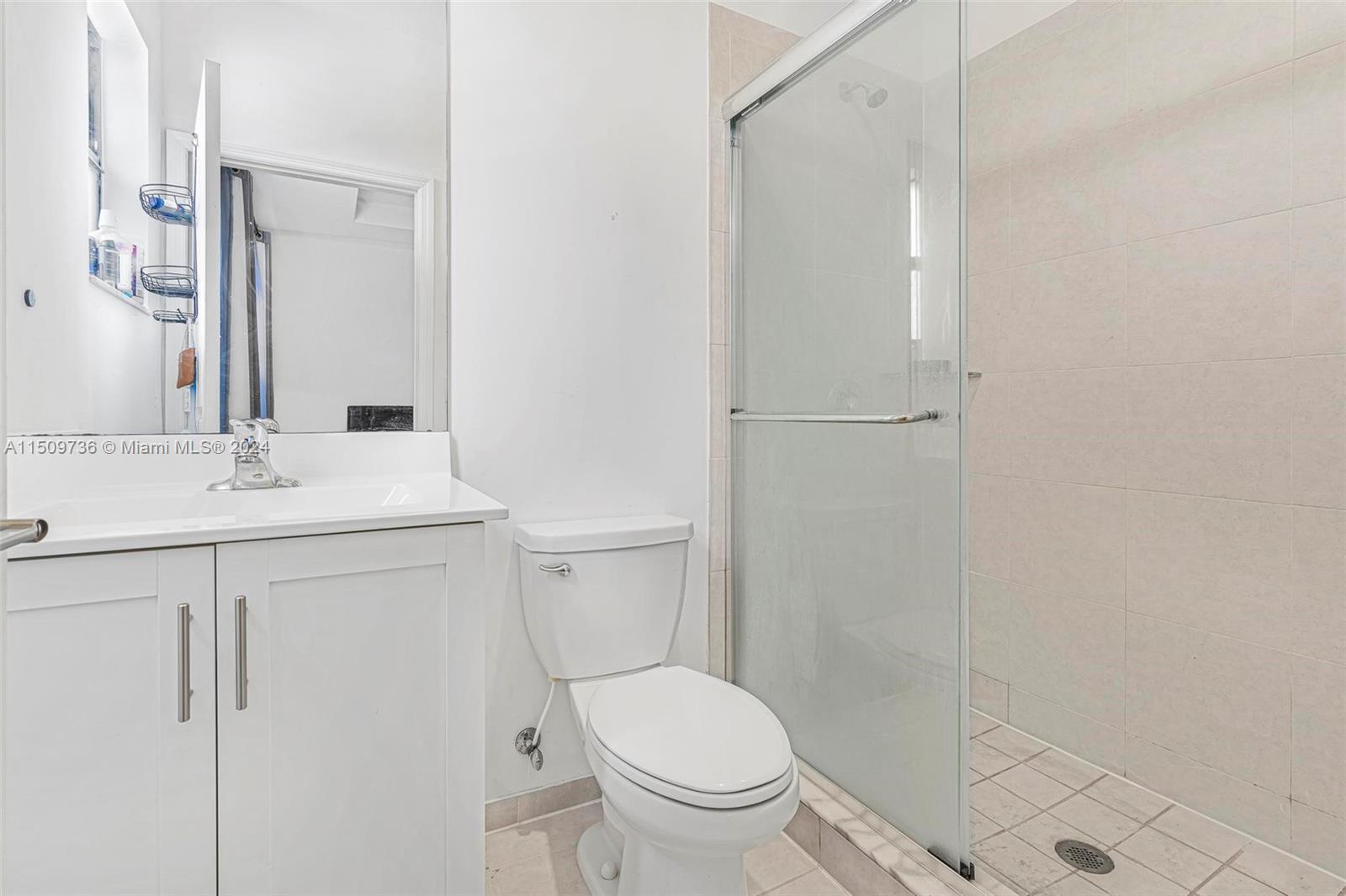 18180 Southwest 148th Road, Unit 18180 Miami, FL 33187 - Photo 12 of 29 a bathroom with a sink a toilet and shower