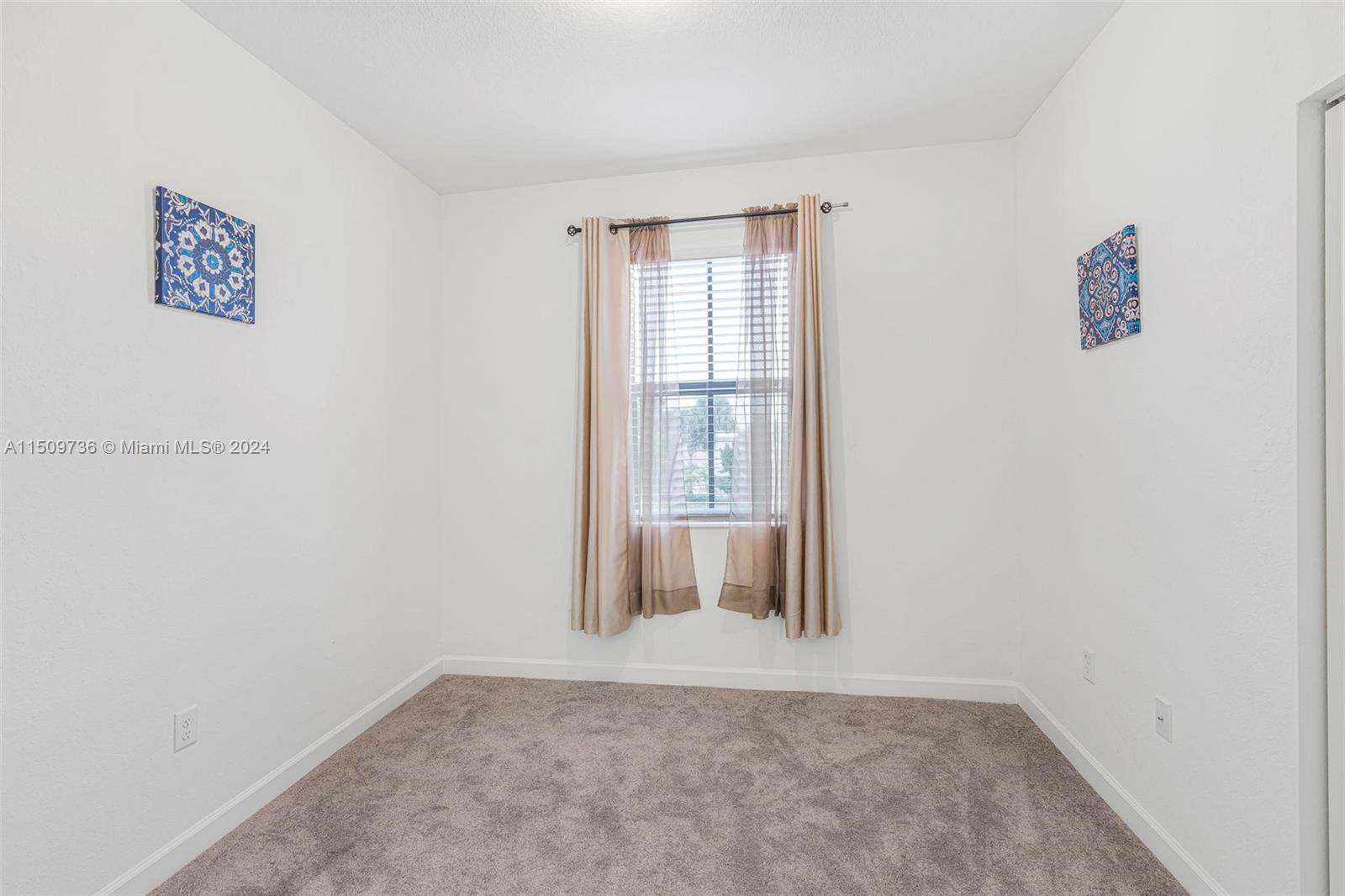 18180 Southwest 148th Road, Unit 18180 Miami, FL 33187 - Photo 14 of 29 a view of an empty room with a window