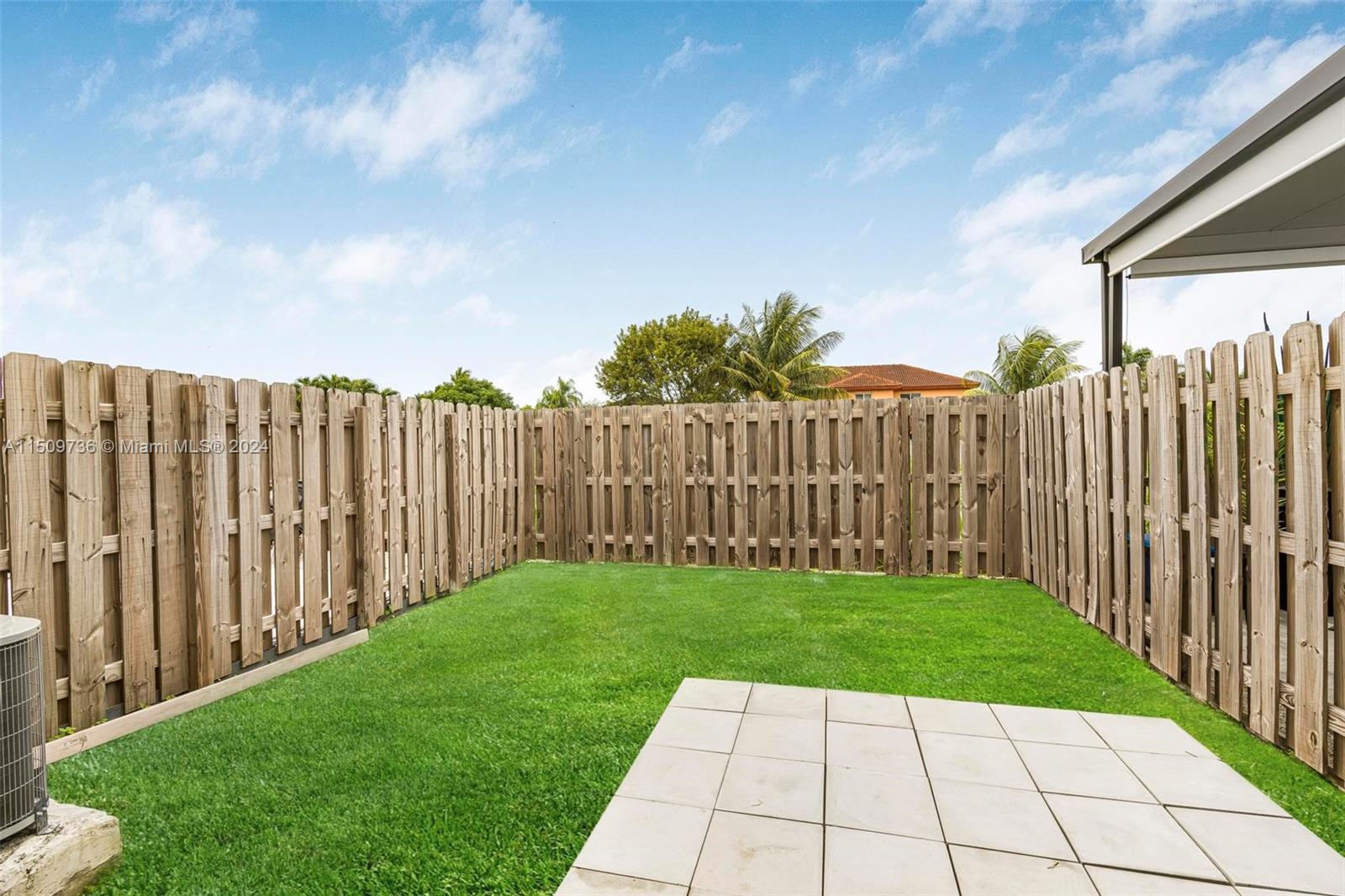 18180 Southwest 148th Road, Unit 18180 Miami, FL 33187 - Photo 16 of 29 a view of a backyard with wooden fence