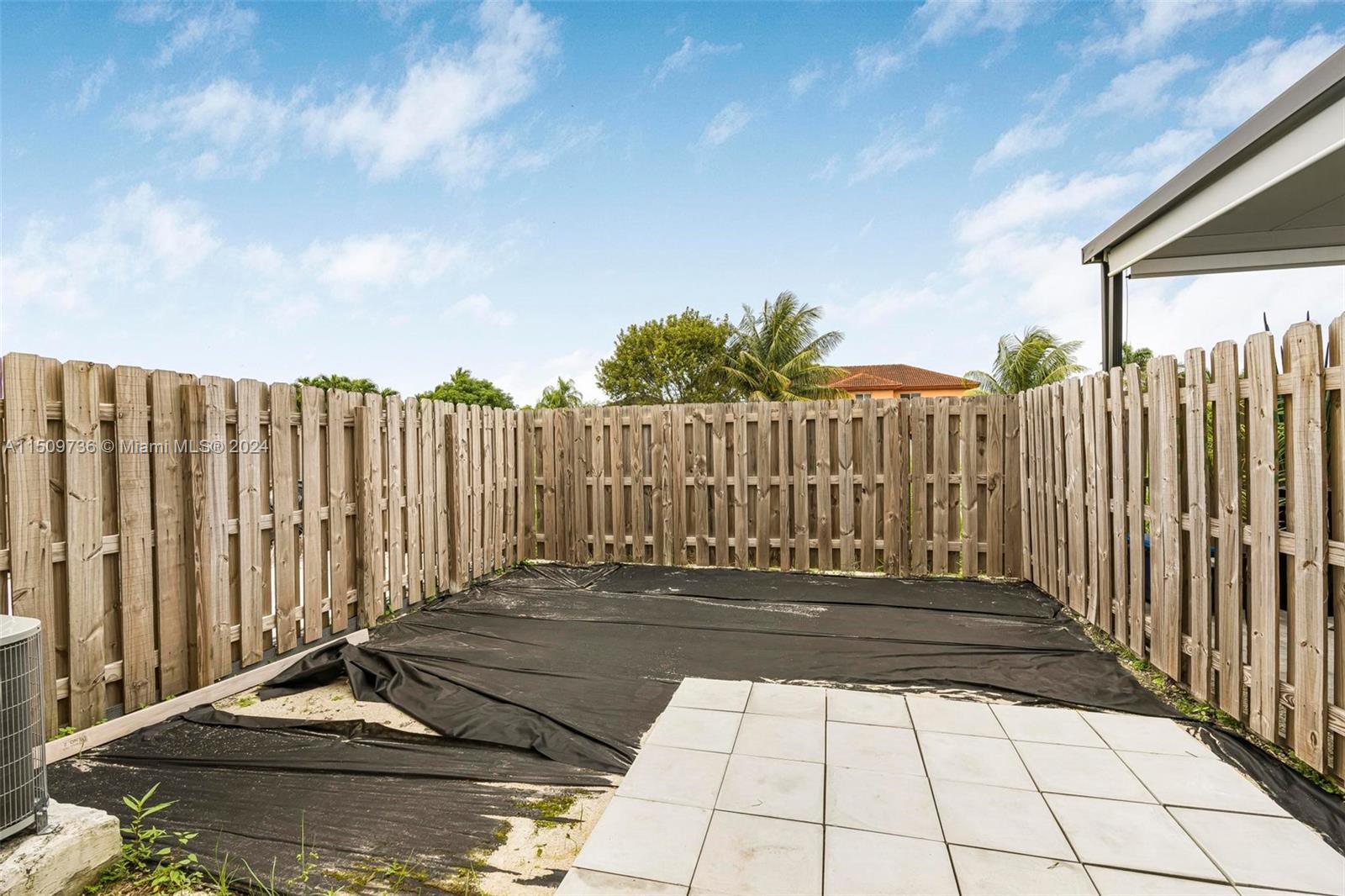 18180 Southwest 148th Road, Unit 18180 Miami, FL 33187 - Photo 17 of 29 a view of a backyard with wooden fence