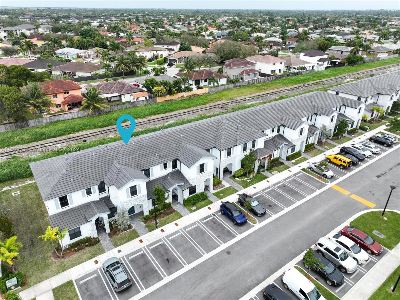 18180 Southwest 148th Road, Unit 18180 Miami, FL 33187 - Photo 18 of 29 an aerial view of a city with streets and houses