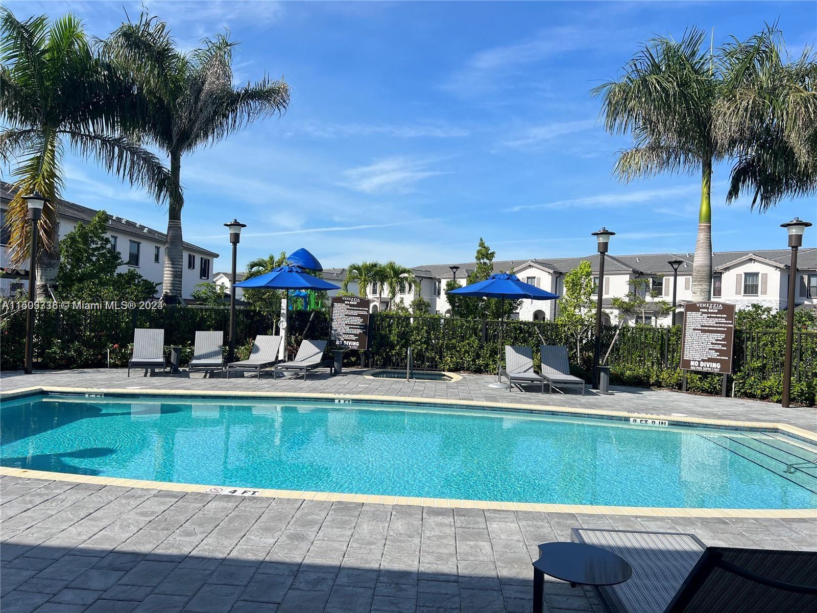 18180 Southwest 148th Road, Unit 18180 Miami, FL 33187 - Photo 24 of 29 a view of a swimming pool with a house