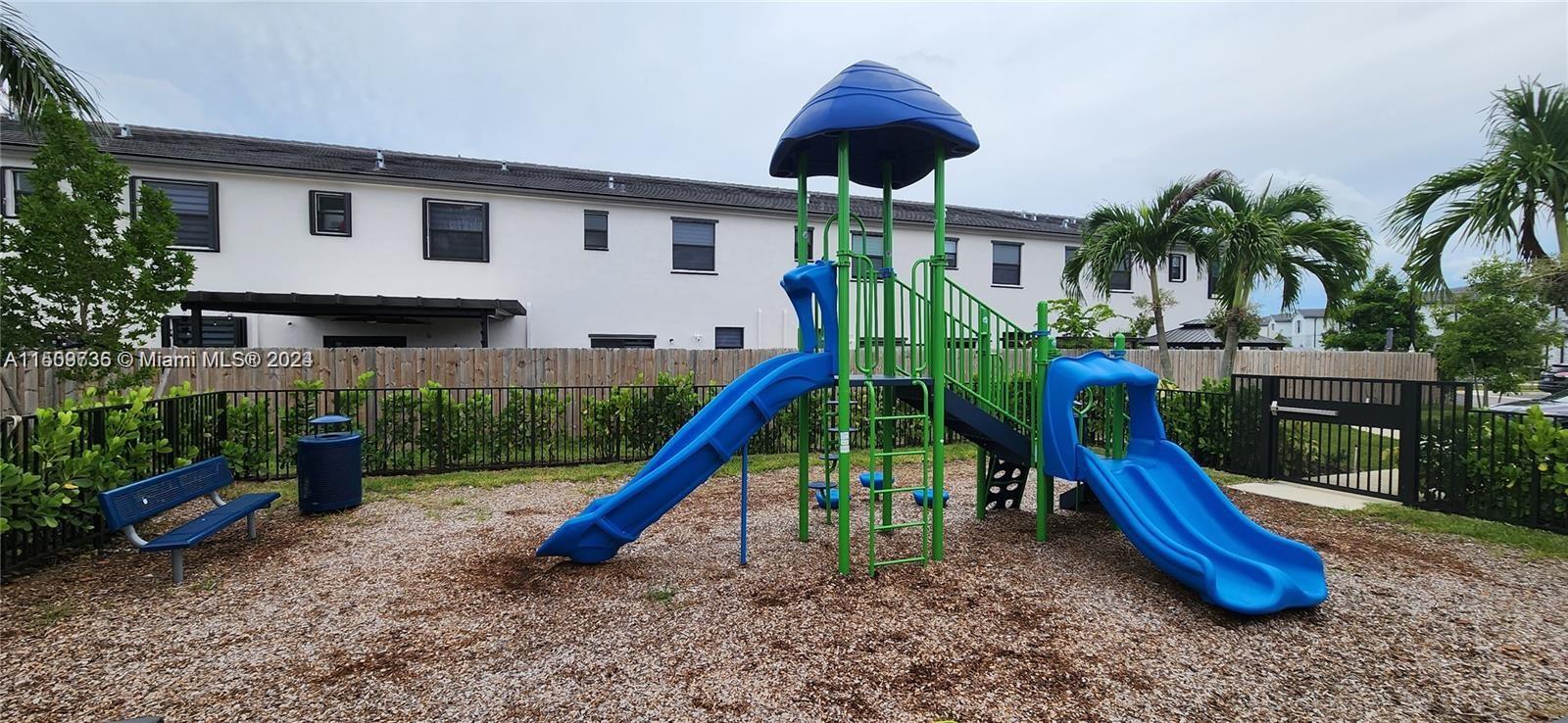 18180 Southwest 148th Road, Unit 18180 Miami, FL 33187 - Photo 27 of 29 a view of a house with a backyard and a slide