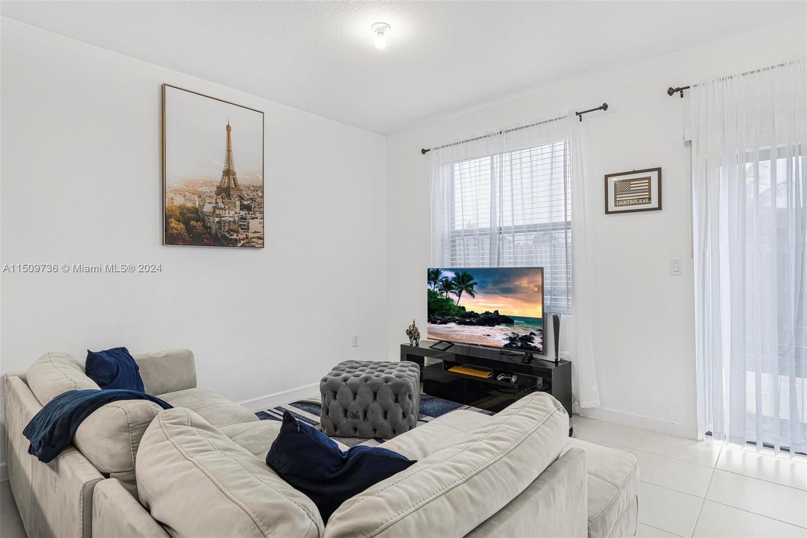 18180 Southwest 148th Road, Unit 18180 Miami, FL 33187 - Photo 5 of 29 a living room with furniture and a flat screen tv