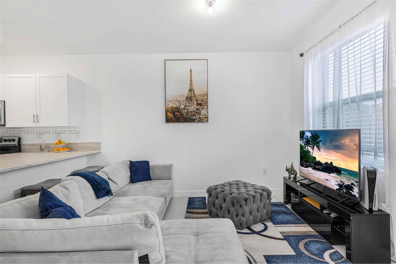 18180 Southwest 148th Road, Unit 18180 Miami, FL 33187 - Photo 6 of 29 a living room with furniture and a flat screen tv