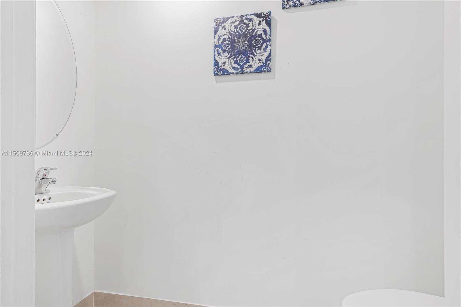 18180 Southwest 148th Road, Unit 18180 Miami, FL 33187 - Photo 8 of 29 a bathroom with a sink and a mirror