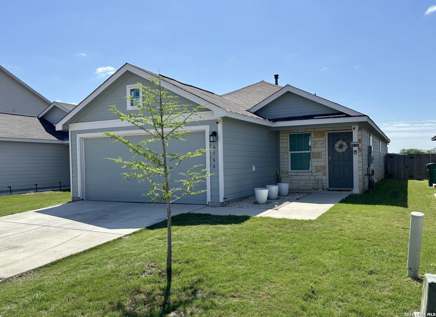 6566 Runaway Row Converse, TX 78109 - Photo 2 of 27 a front view of a house with a yard and garage