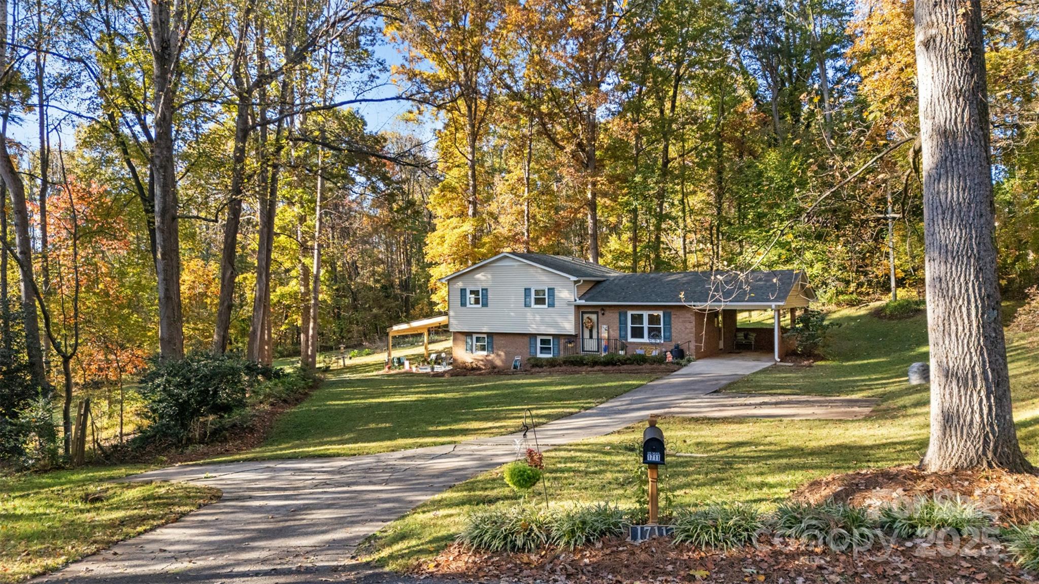 1711 McCombs Street Newton, NC 28658 - Photo 1 of 41 a view of a house with a big yard and large trees