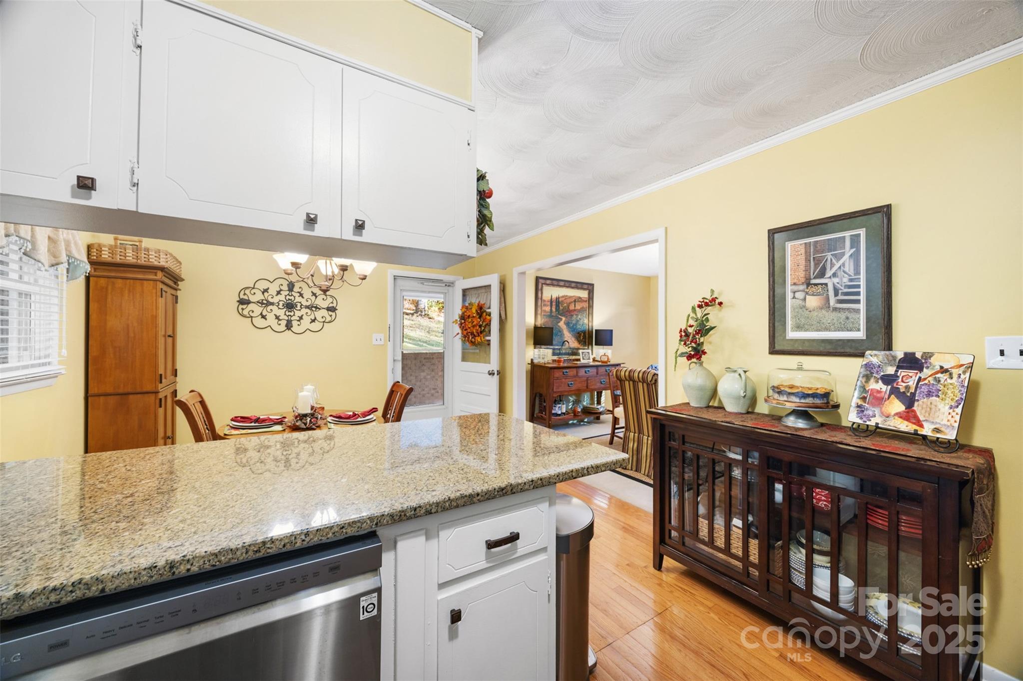 1711 McCombs Street Newton, NC 28658 - Photo 13 of 41 a kitchen with stainless steel appliances granite countertop a sink a stove and a wooden cabinets