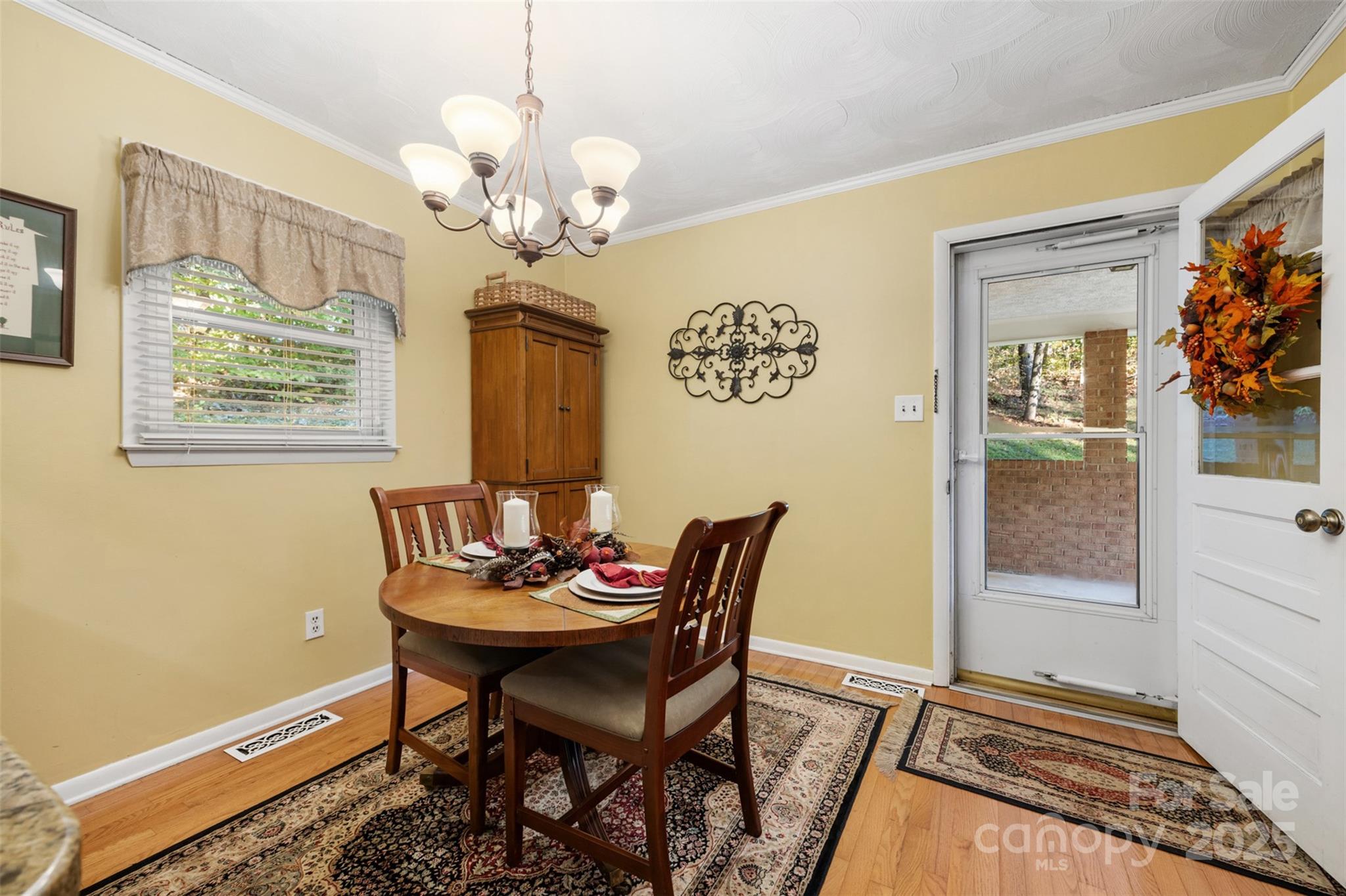 1711 McCombs Street Newton, NC 28658 - Photo 15 of 41 a dining room with chandelier and wooden floor