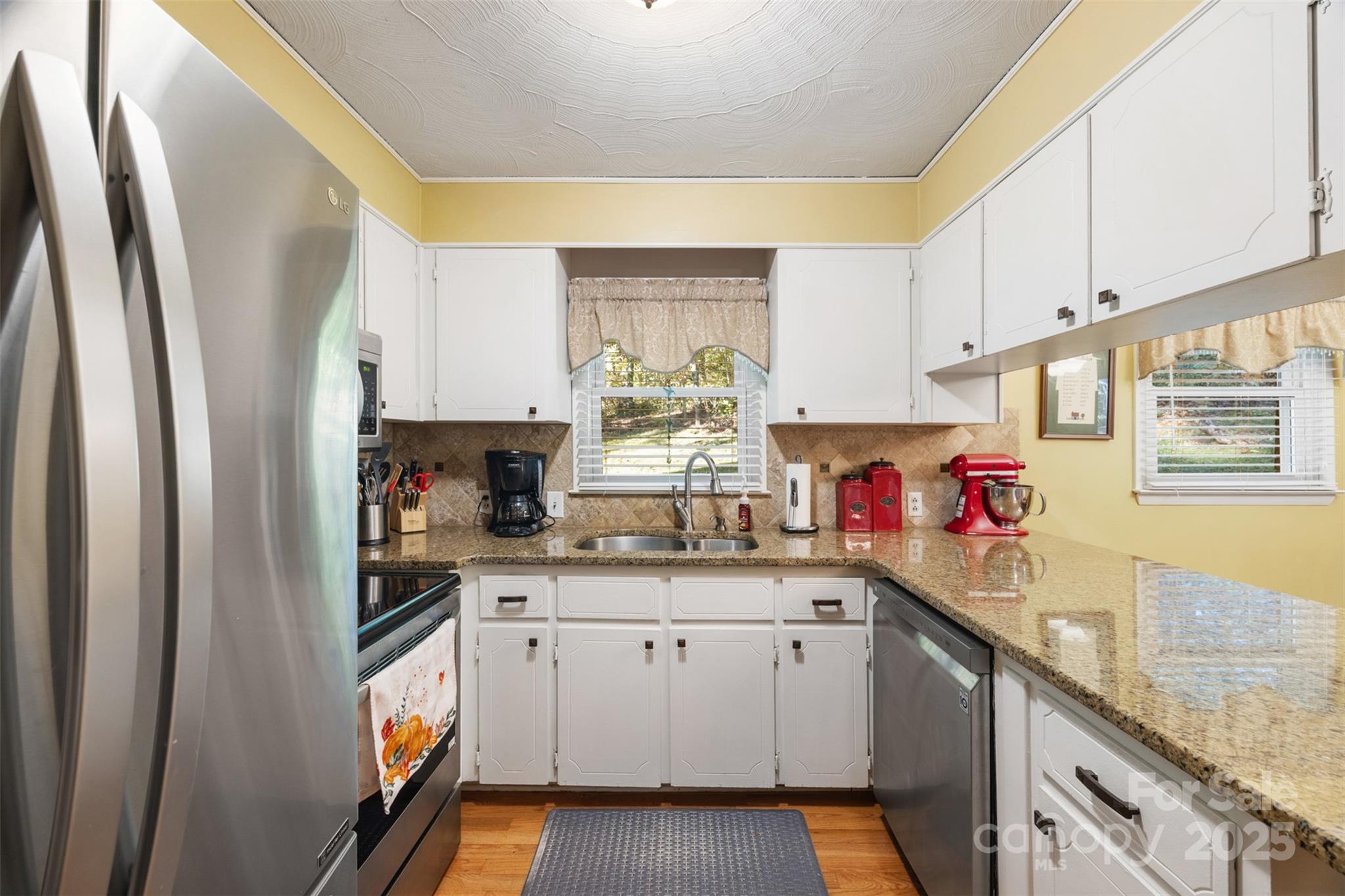 1711 McCombs Street Newton, NC 28658 - Photo 2 of 41 a kitchen with stainless steel appliances granite countertop a refrigerator sink and cabinets