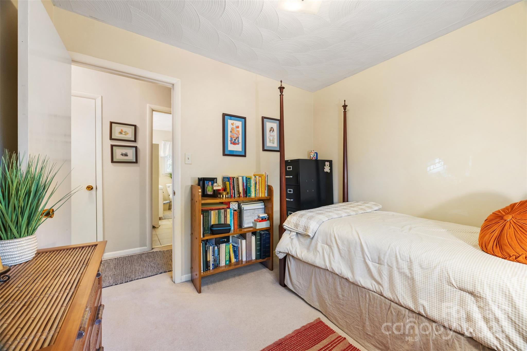 1711 McCombs Street Newton, NC 28658 - Photo 22 of 41 a bedroom with a bed and a book shelf
