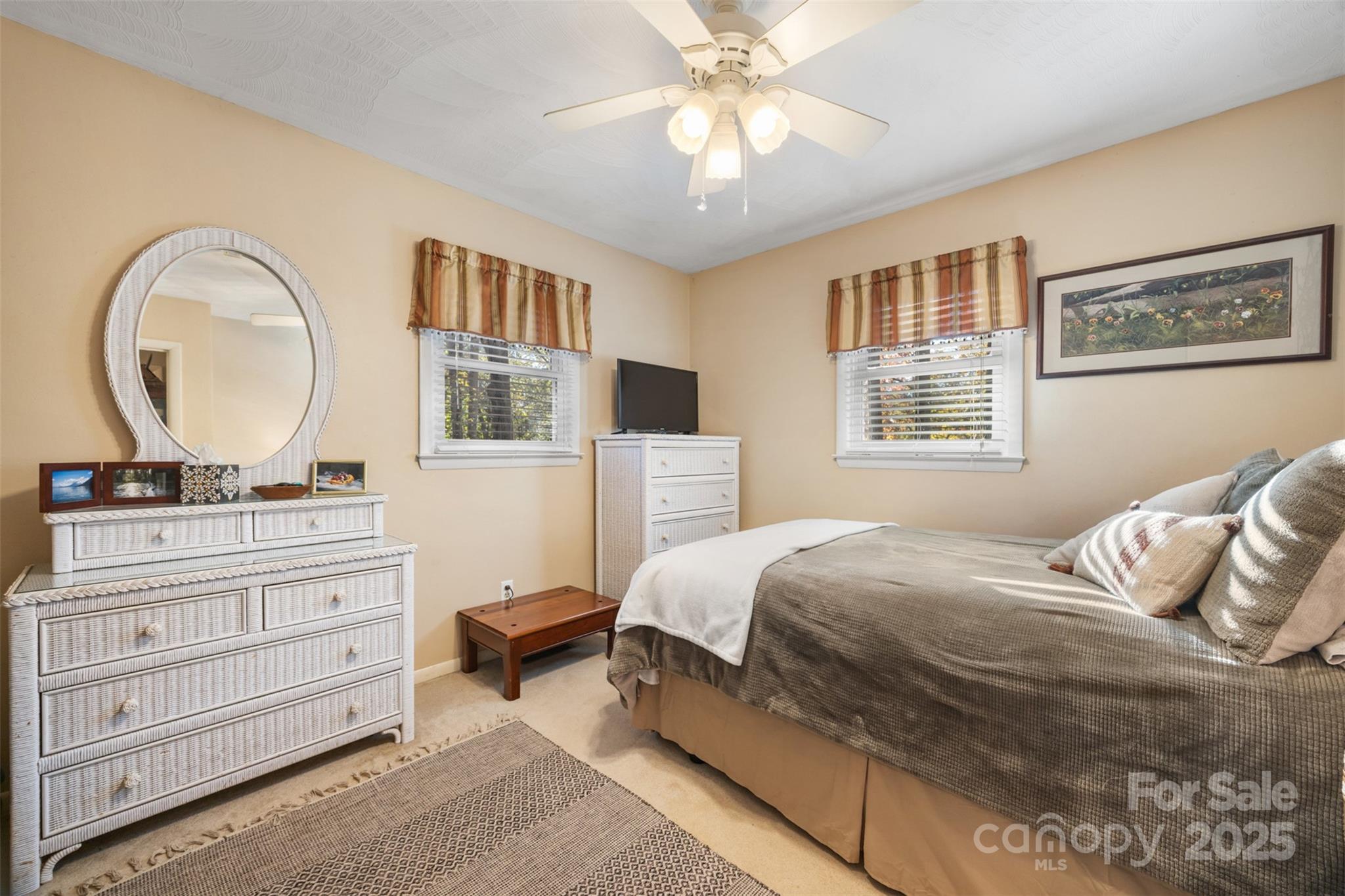 1711 McCombs Street Newton, NC 28658 - Photo 25 of 41 a bedroom with a large bed and a chandelier