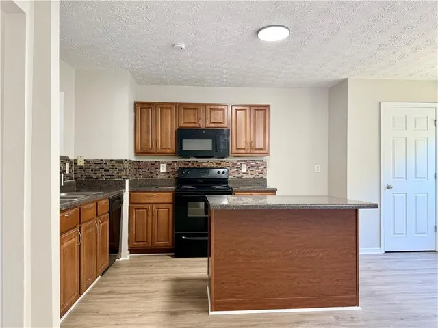 a kitchen with stainless steel appliances granite countertop a stove and a sink