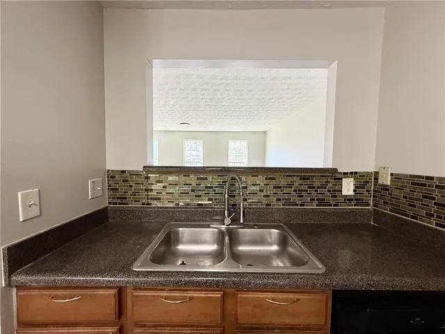 a bathroom with a granite countertop sink a mirror and vanity