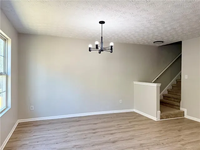 a view of a room with wooden floor and stairs