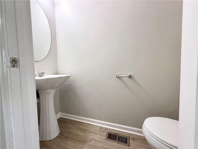 a bathroom with a sink a toilet and a mirror