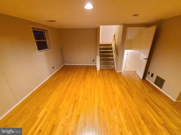 a view of a room with wooden floor and stairs