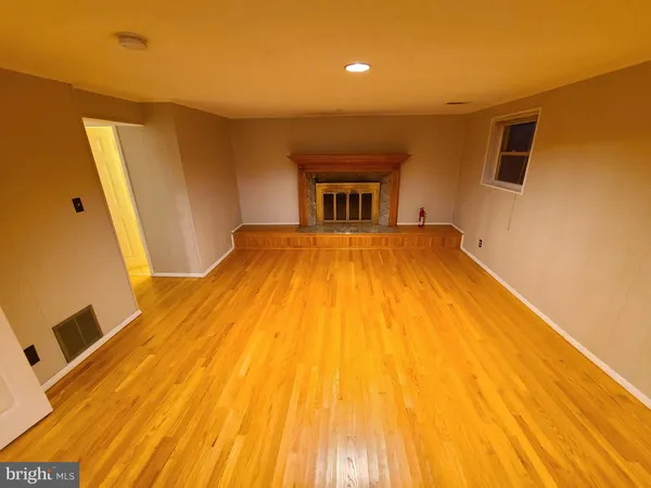 a room with a bed and wooden floor