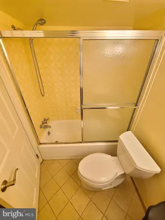 a white toilet sitting next to a bathroom