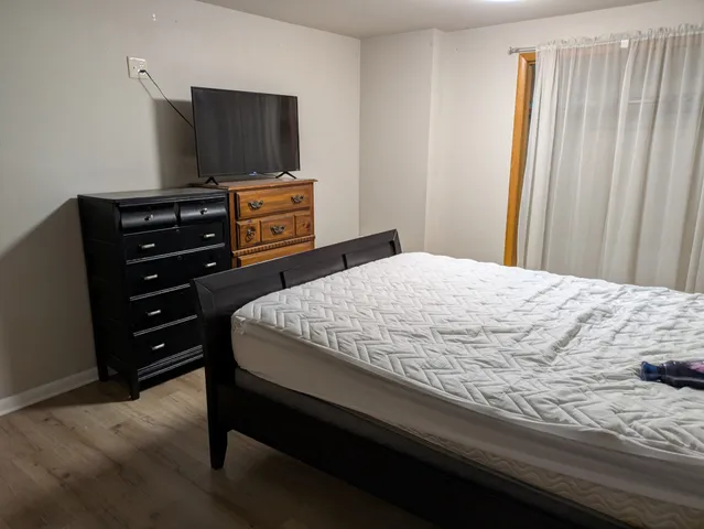 a bedroom with a bed and flat screen tv