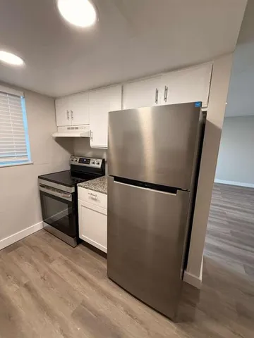 a white refrigerator freezer sitting in a kitchen