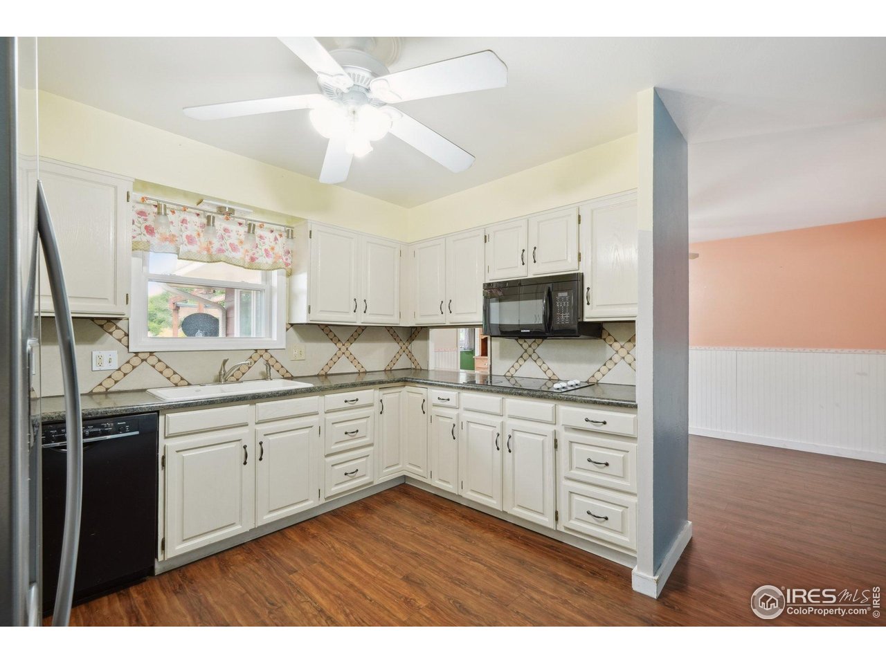 2001 Evergreen Drive Fort Collins, CO 80521 - Photo 11 of 39 a kitchen with granite countertop a sink stainless steel appliances and cabinets