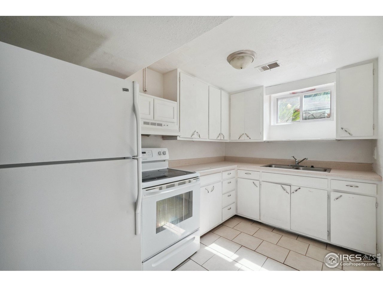2001 Evergreen Drive Fort Collins, CO 80521 - Photo 25 of 39 a kitchen with stainless steel appliances granite countertop a refrigerator sink and cabinets
