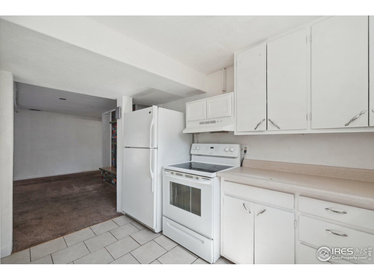 2001 Evergreen Drive Fort Collins, CO 80521 - Photo 26 of 39 a kitchen with white cabinets and white appliances