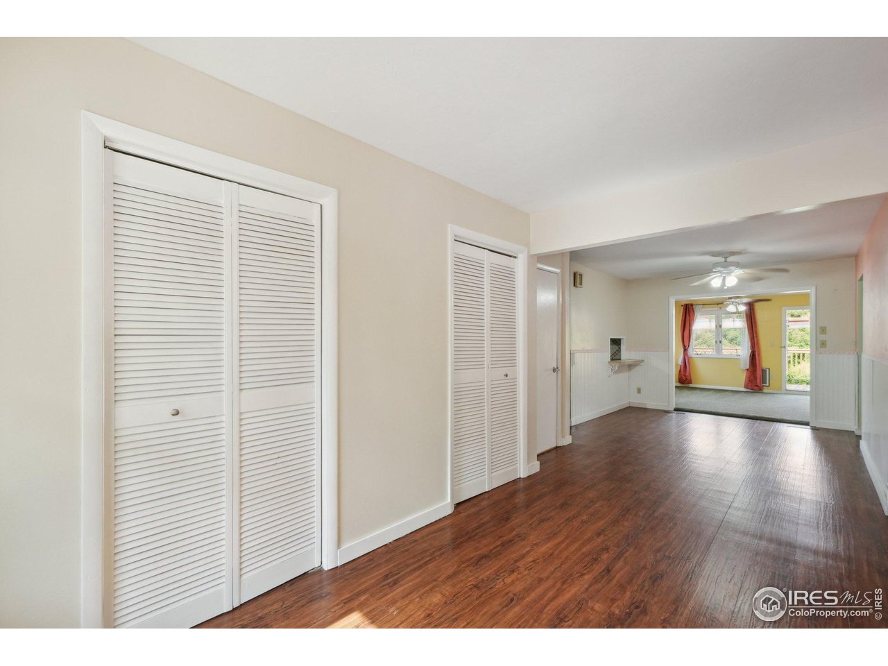 2001 Evergreen Drive Fort Collins, CO 80521 - Photo 5 of 39 a view of an empty room with window and wooden floor
