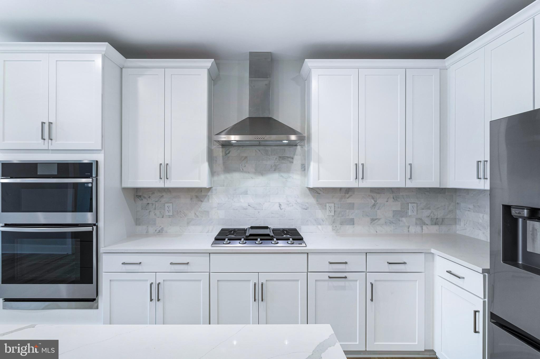 76 Old Mill Bottom Road North, Unit 308 Annapolis, MD 21409 - Photo 17 of 38 a kitchen with white cabinets and a stove
