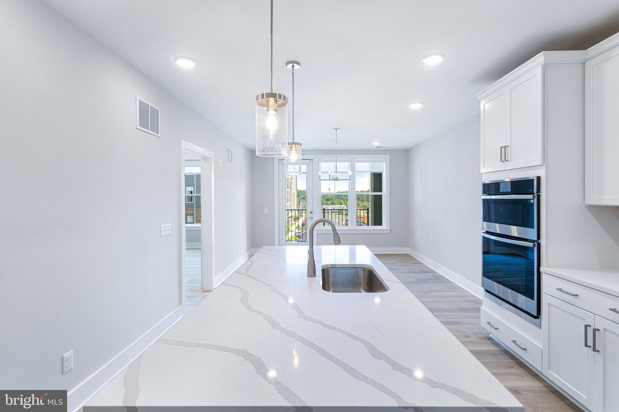 76 Old Mill Bottom Road North, Unit 308 Annapolis, MD 21409 - Photo 19 of 38 a large white kitchen with a large window a oven and stainless steel appliances