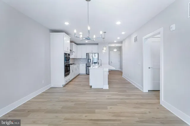 a view of kitchen with cabinets and wooden floor