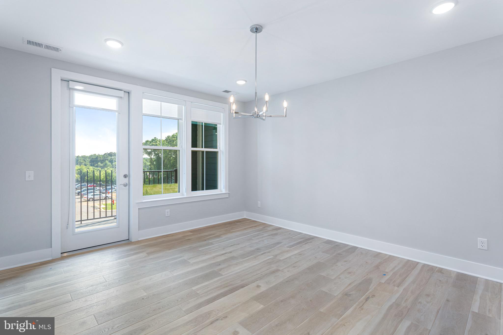 76 Old Mill Bottom Road North, Unit 308 Annapolis, MD 21409 - Photo 26 of 38 an empty room with wooden floor and windows
