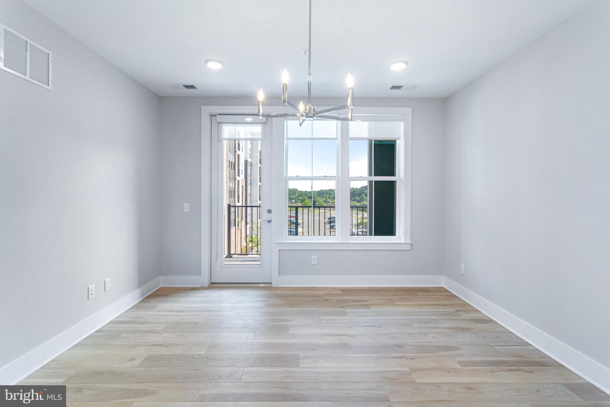 76 Old Mill Bottom Road North, Unit 308 Annapolis, MD 21409 - Photo 27 of 38 an empty room with wooden floor and windows