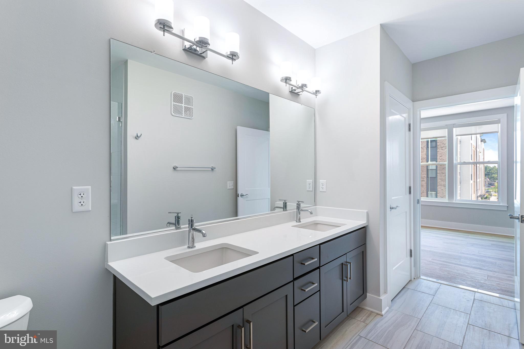 76 Old Mill Bottom Road North, Unit 308 Annapolis, MD 21409 - Photo 29 of 38 a bathroom with a sink and a mirror
