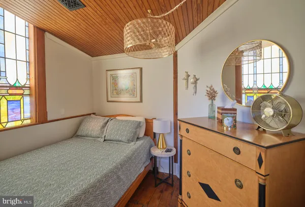 a bedroom with furniture and a large window