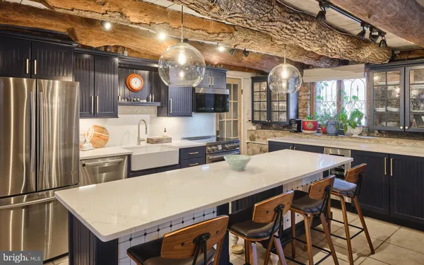 a kitchen with stainless steel appliances granite countertop a sink stove and cabinets