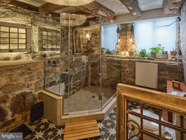 a room with stainless steel appliances kitchen island granite countertop furniture and a fireplace