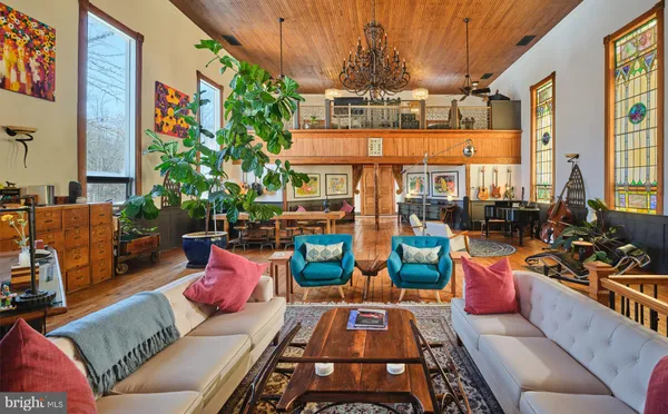 a living room with furniture fireplace and window