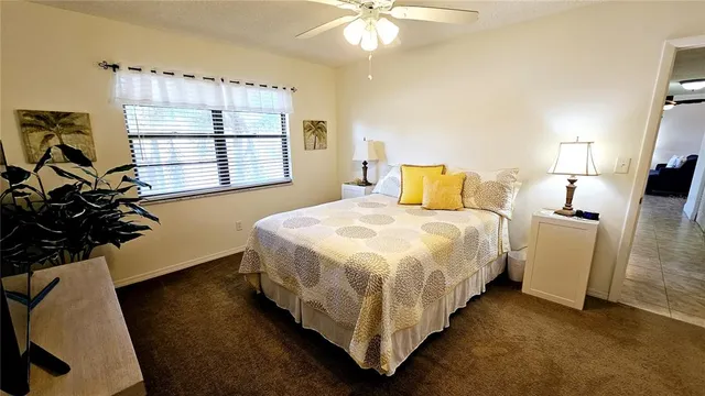 a bedroom with bed and a large window