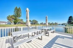 a view of a balcony with wooden floor and outdoor seating