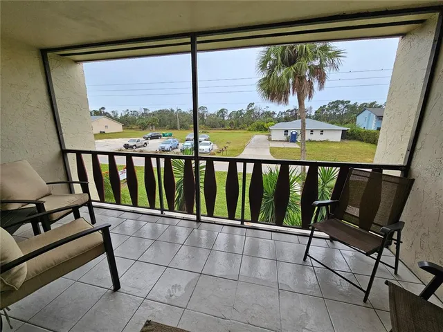 a view of a balcony with chairs