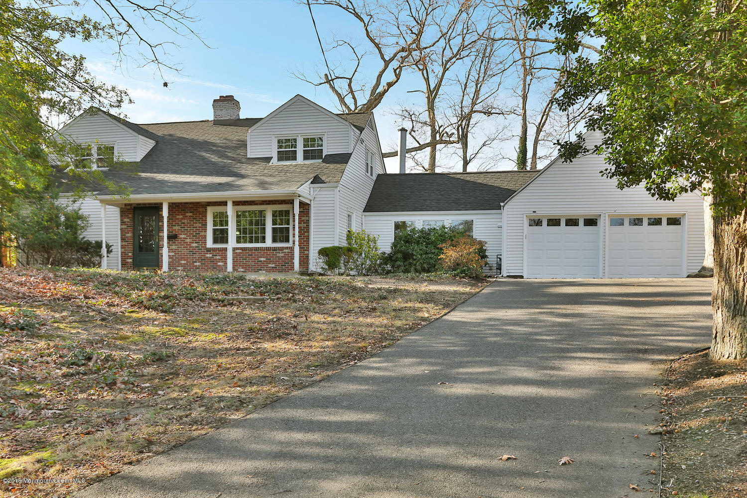 717 Schoolhouse Road Brielle, NJ 08730 - Photo 2 of 22 a front view of a house with a yard
