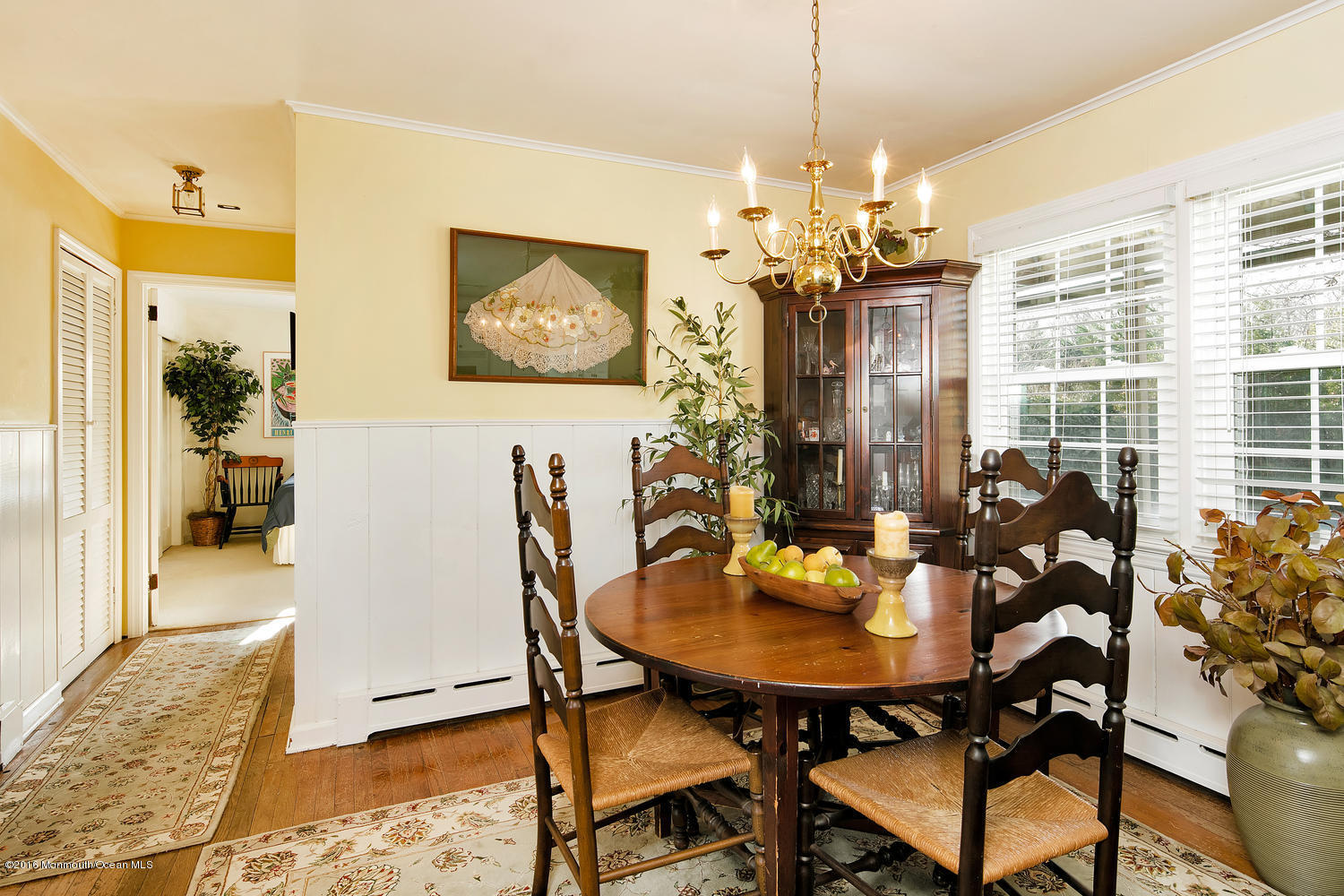 717 Schoolhouse Road Brielle, NJ 08730 - Photo 9 of 22 a view of a dining room with furniture and a chandelier