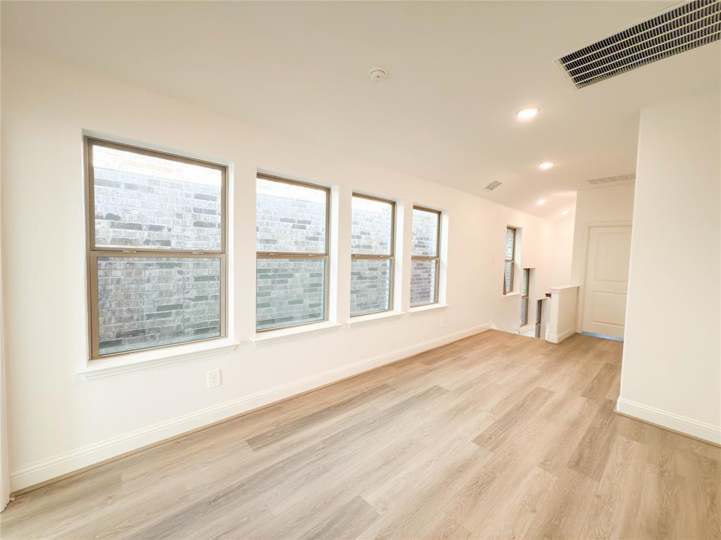 114 Settlers Way Euless, TX 76040 - Photo 17 of 38 a view of an empty room with a window and wooden floor
